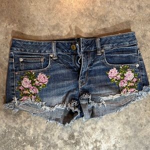 Floral embroidered cutoff denim shorts